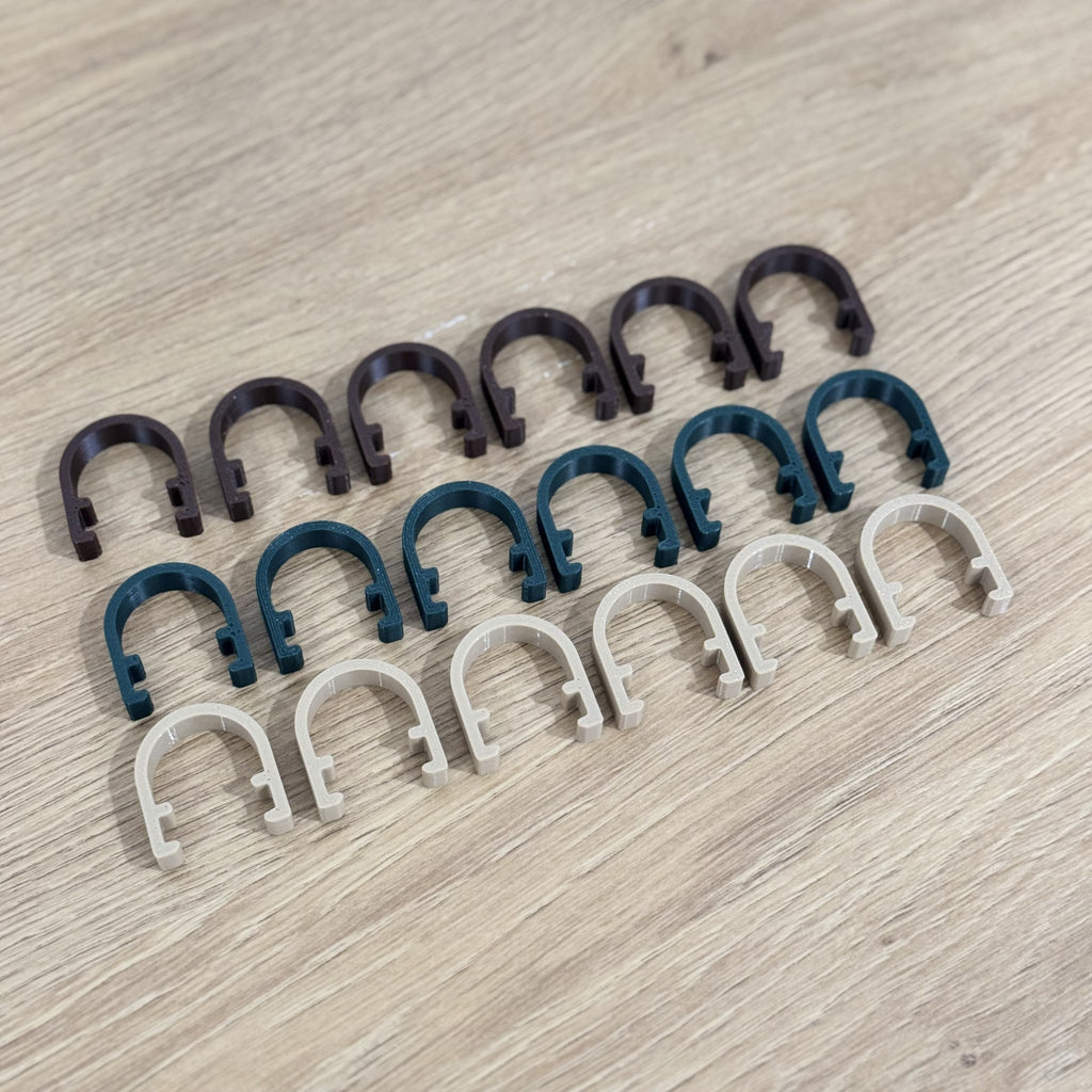 Rows of Brown, Pine Green and Oak plant clamps