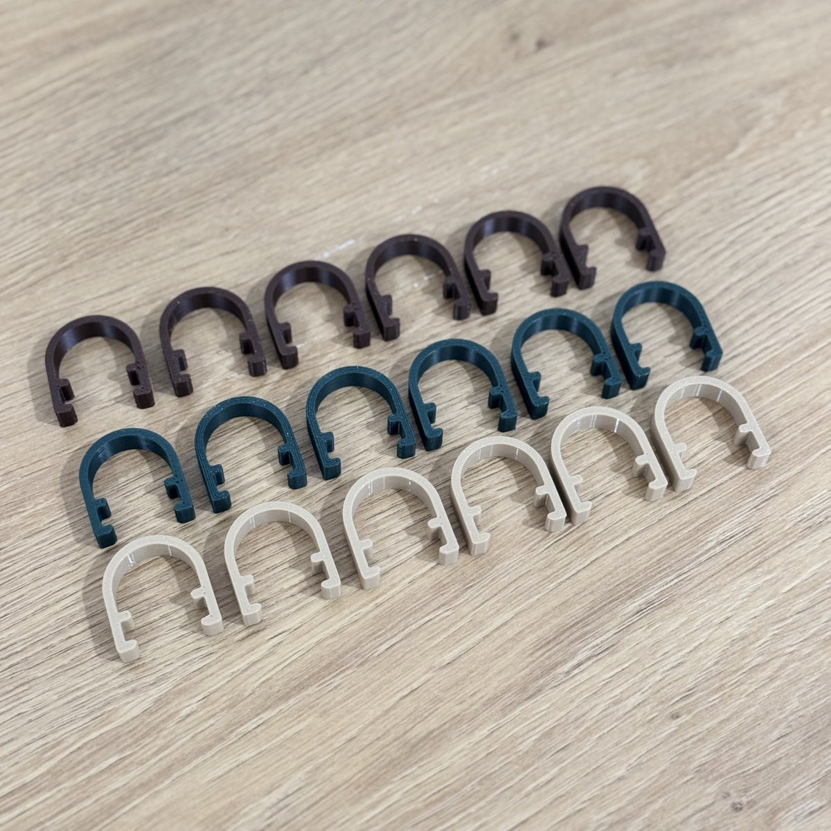 Rows of Brown, Pine Green and Oak plant clamps